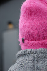 
Woman wearing a homemade cerise hat in hot pink or fuchsia on a gray background