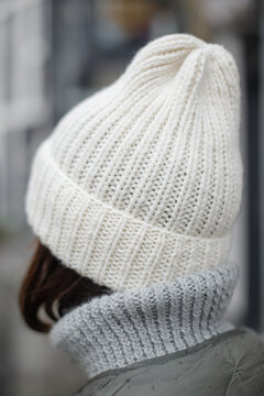 
Close-up shot of a handmade knitted wool hat in white color. Fashionable actual hat for the autumn-winter-spring season. Alpaca wool