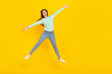 Fototapeta na wymiar Full size photo of young girl have fun jumper dream wear casual clothes isolated over yellow color background