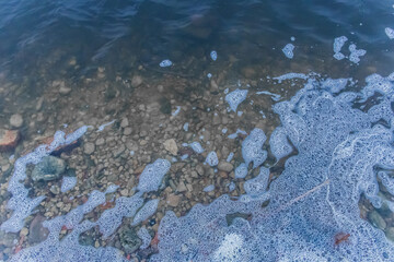 Foam abstract natural foamy pattern on the surface of the water lake background texture