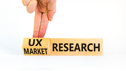 UX or market research symbol. Businessman turns wooden cubes and changes words Market research to...