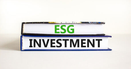 ESG environmental social governance investment symbol. Concept words ESG investment on books on a beautiful white table white background. Business, ESG investment concept. Copy space.