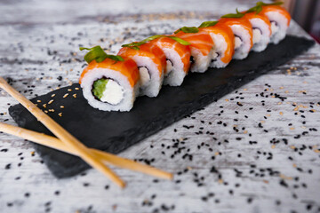 light salmon sushi philadelphia on black desk white background