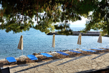 Sunbeds on the beach at luxury hotel, Peloponnes, Greece - 486346099