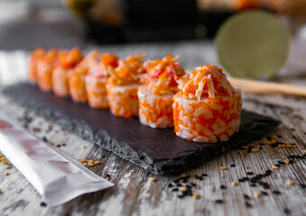 Crab sticks Sushi Japanese Food Style, Crab sticks Sushi roll on the black desk