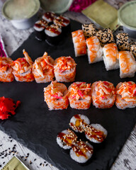 Sushi Set nigiri and sushi rolls on black stone slate plate board