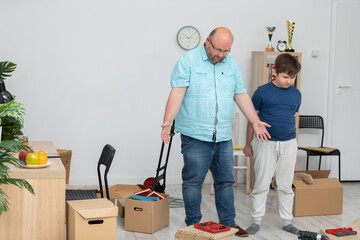 A father and son set about assembling a bookcase.