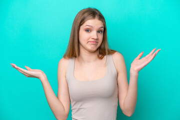 Teenager Russian girl isolated on blue background making doubts gesture