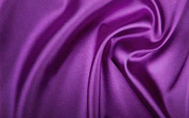Deep, rich, purple colored satin. Folded and flowing background. Luxury fashion concept. Trend color 2022 - Velvet Violet