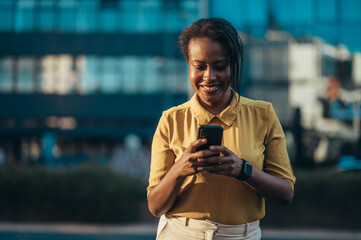 African american woman using a smartphone while out in the city