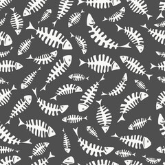 Seamless pattern with abstract skeletons of white fish on a dark gray background