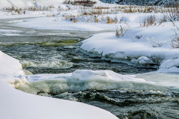 Ice from the river water and snow close-up in winter