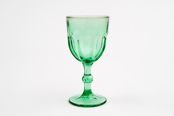 Isolated green wine glass champagne glass. Gray background.