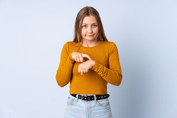 Teenager Ukrainian girl isolated on blue background making the gesture of being late