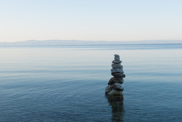 Balance stone pyramid on the sea coast
