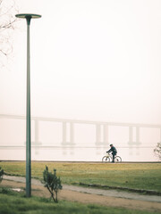 Man cycling on the riverbank in Parque das Nações