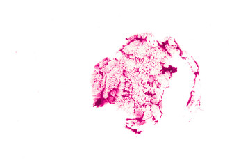 Close-up of the creamy texture of makeup.The crimson color of the cosmetic product. A lipstick stain stands out against a white isolated background. High quality photo