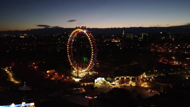 Flying to ferris wheel areal city view