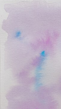 Background with abstract ink stains made with watercolor in blue, purple and pink colors on textured paper