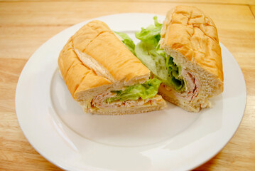 Ham and Chicken Deli Sandwich Served on a White Plate