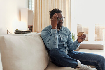 Man with problem using credit card for online shopping. Man having problems with credit card, using...