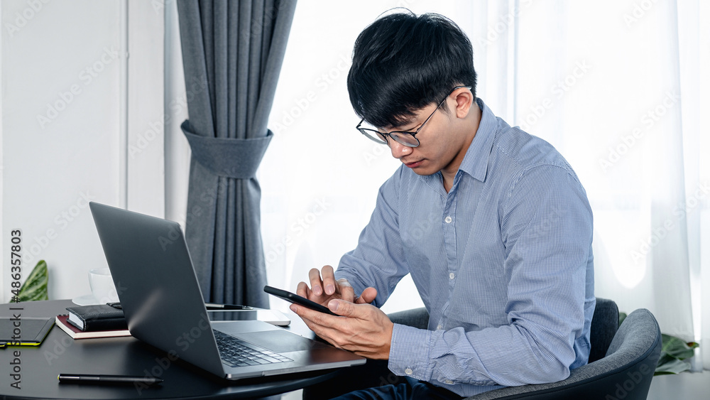 Poster Businessman using smartphone to checking email and reply idea of strategy to boss while sitting to working