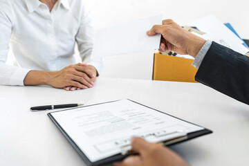 Hand of employer filing final remuneration after employee to write a document letter of resignation, resign concept