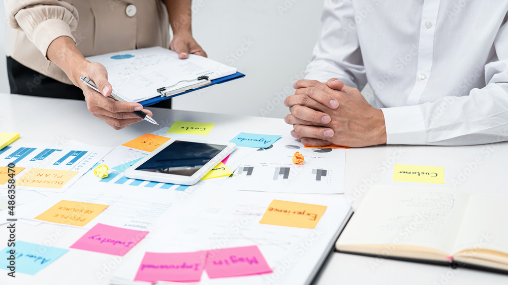 Poster Businesswoman holding document and pointing data on tablet to explaining business report to executive