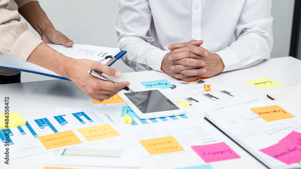 Poster Businesswoman holding document and pointing data on tablet to explaining business report to executive