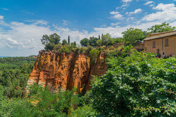 Roussillon, Vaucluse - France - July 11 2021: Views of the ocher mountain and the vegetation of...