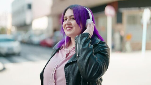 Young plus size woman smiling confident listening to music at street