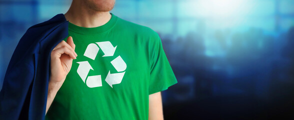 Man showing chest with Recycling Symbol logo on green t-shirt. Corporate office on blurred...
