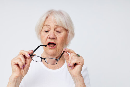 Photo of retired old lady vision problems with glasses close-up