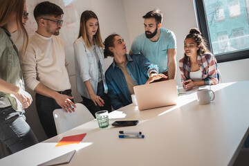 Software developing workers at a meeting  in conference room. They discuss future projects.	
