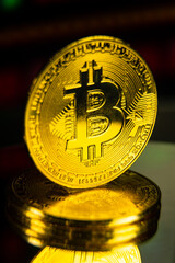 Close up macro shot of golden bitcoin on stack of coins. Virtual money future of world finance concept. 