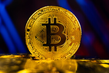 Golden bitcoin standing on pile of coins with blockchain technology background. Crypto currency mining concept. Future and virtual money