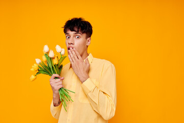 handsome guy in yellow glasses with a bouquet of flowers isolated background unaltered