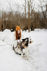 cheerful woman outdoors in a field in winter walking with a dog Lifestyle