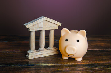 Piggy bank near the state building. Savings deposit in the bank. Use of investment instruments to increase funds, reduce inflationary risks. Budget. Tax collection. Financial system, commerce