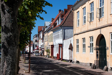 Fototapeta na wymiar Street of old town on a summer sunny day. Expensive housing in the center of the city. Rent an apartment. Real estate investment. Tourism in Denmark.