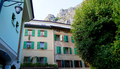 an old quaint street in the picturesque mediterranean town of Limone sul Garda with the mountains in the background, Italy (Lombardy)