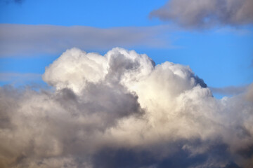 Bright landscape of white puffy cumulus clouds on blue clear sky