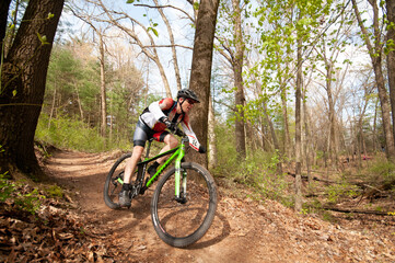 Fototapeta na wymiar mountain biking in the forest with motion blur