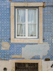 Facade with tiles and wooden window gives vintage style to the Center of Lisbon, Portugal.
