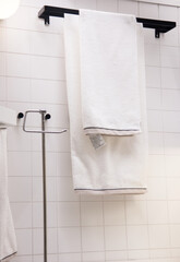 towels hanging in the bathroom on a towel rack. bathroom