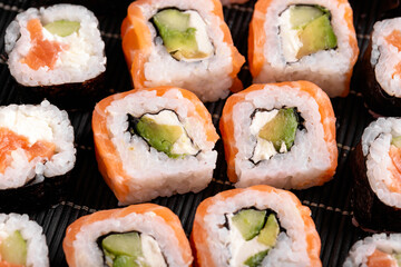 Sushi Rolls Philadelphia with salmon, avocado, soft cheese