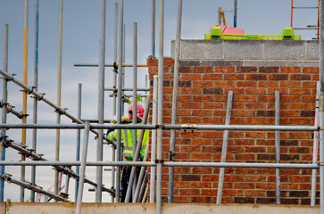 Scaffolder erection scaffolds during new residential house construction