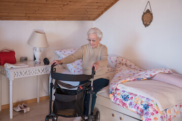 Senior woman with rollator at home - 486371402
