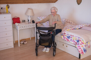 Senior woman with rollator at home in bedroom - 486371420