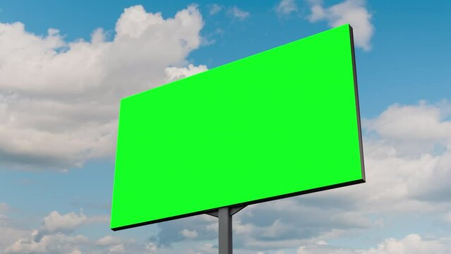 Blank green billboard or large advertising display and moving white clouds against blue sky - timelapse. Chroma key, green screen, template, mock up, copy space and time lapse concept
